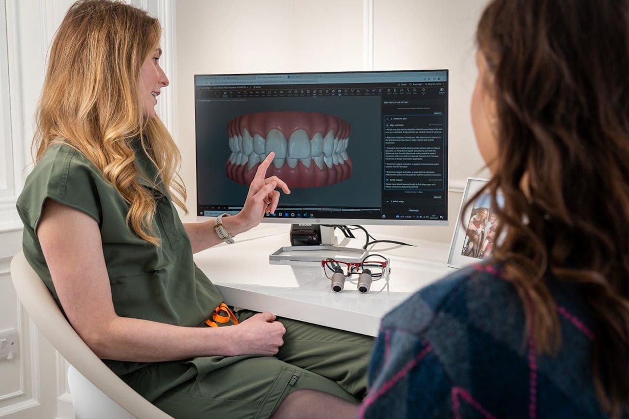Dentist explaining a dental treatment plan to a patient using digital imaging