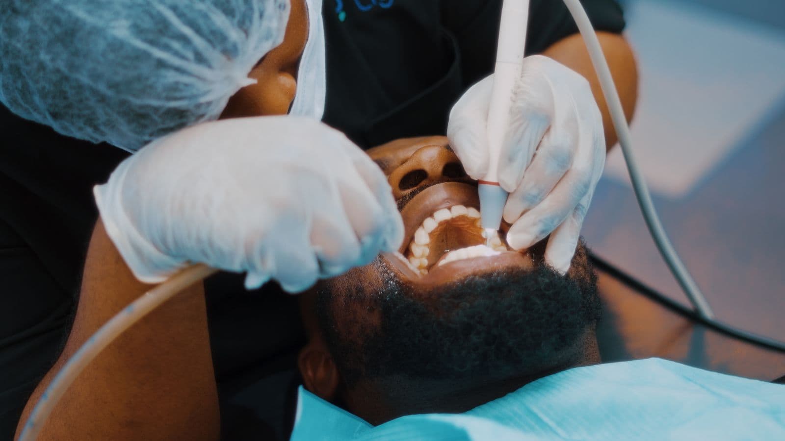 Dentist performing a professional scale and clean on a patient during a check-up appointment