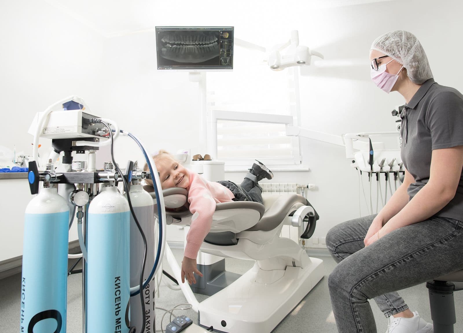 Child relaxing in dental chair during a first dentist appointment